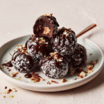 No-Bake Brownie Balls: 9-Minute Recipe for Guilt-Free Bliss 9 Finished no-bake brownie balls with a bite revealing the fudgy center and crisp chocolate coating.