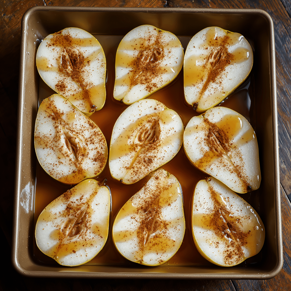 Easy Maple Baked Pears: 4‑Ingredient Comfort in 30 Minutes 7 “Maple vanilla coated pear halves in baking dish ready for oven – step in Easy Maple Baked Pears recipe”