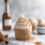 Snickerdoodle Cupcakes with Cinnamon Swirl Frosting – 12 Irresistible Reasons to Bake Them 9 Snickerdoodle Cupcake with Cinnamon Swirl Frosting topped with mini snickerdoodle cookie on a marble cake stand, perfect for fall desserts.