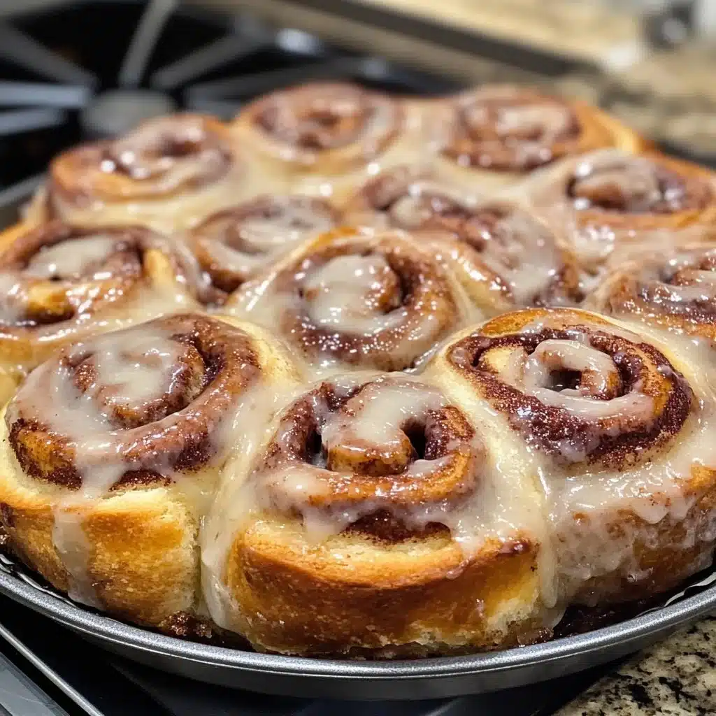 Red Velvet Cinnamon Rolls 2 Red Velvet Cinnamon Rolls with cream cheese icing on a white plate.