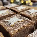 Delicious gingerbread cookie bars topped with icing and festive sprinkles.