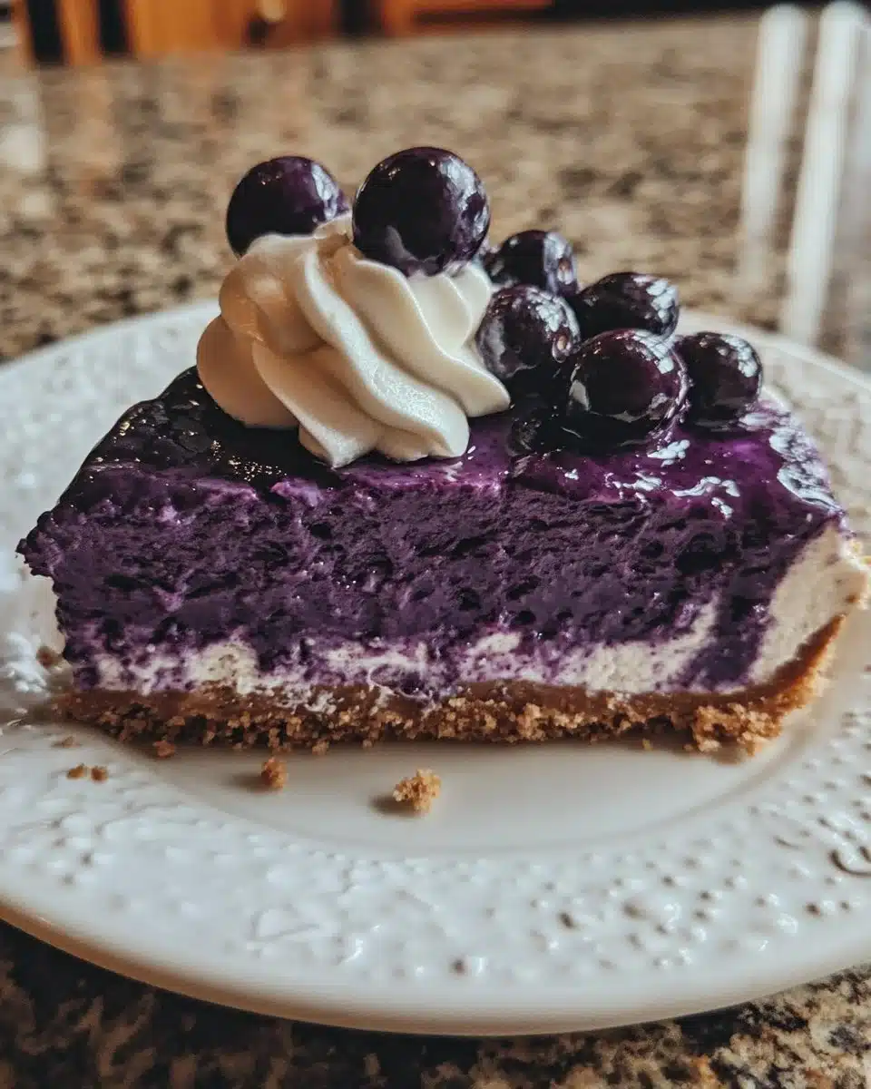 No-bake blueberry cheesecake topped with fresh blueberries and a graham cracker crust