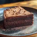 Decadent fudgy chocolate mud cake topped with chocolate ganache and berries