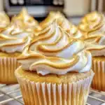 Lemon meringue cupcakes topped with fluffy meringue and lemon zest