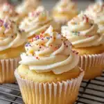 Moist gluten-free vanilla cupcakes topped with creamy frosting