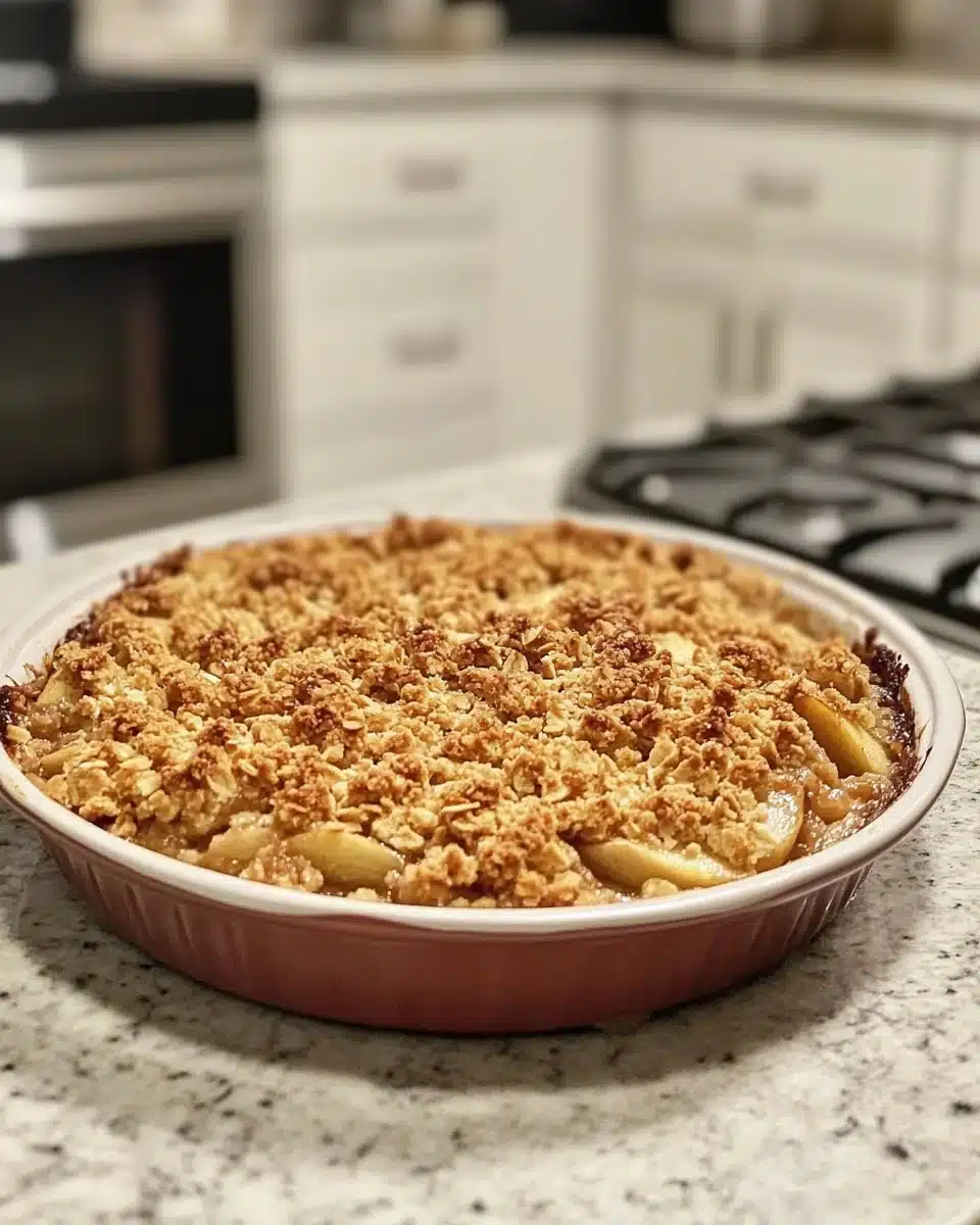 Delicious apple crisp topped with a golden crumble, garnished with cinnamon.